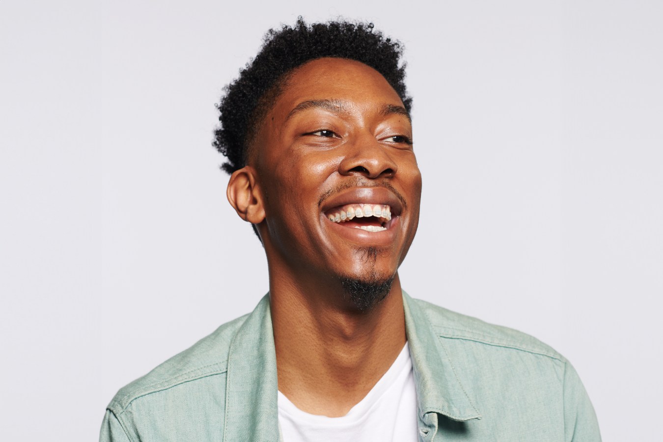 A man smiling and laughing